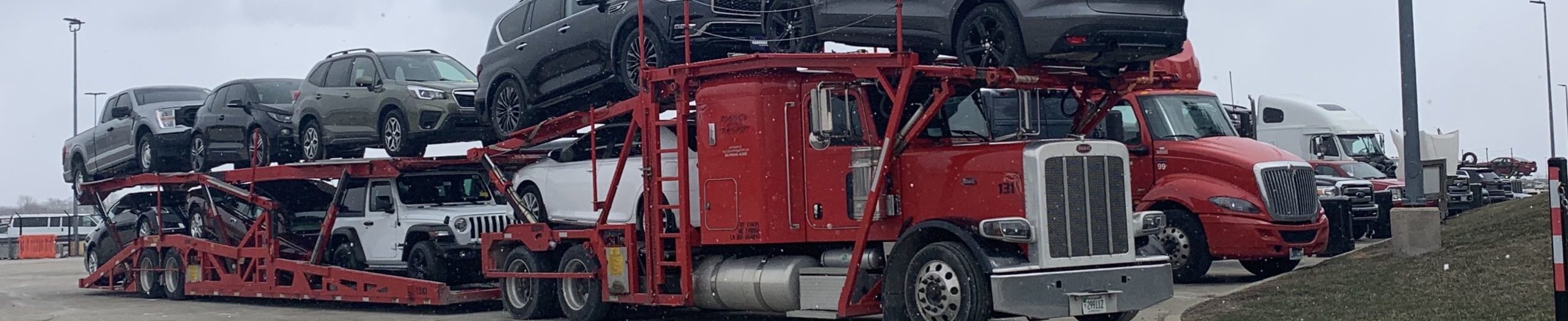 Car hauling truck delivering vehicles to dealerships